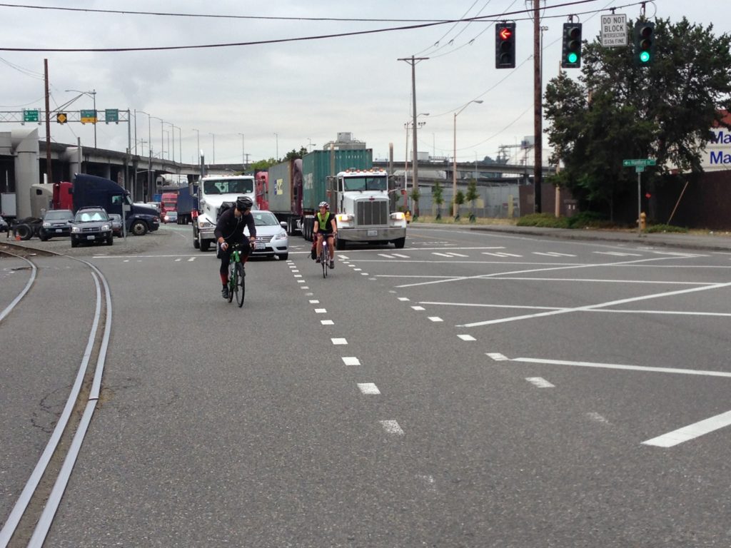 bike riders mixing with car and semi-truck traffic on East Marginal Way South, Seattle