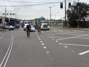 bike riders mixing with car and semi-truck traffic on East Marginal Way South, Seattle
