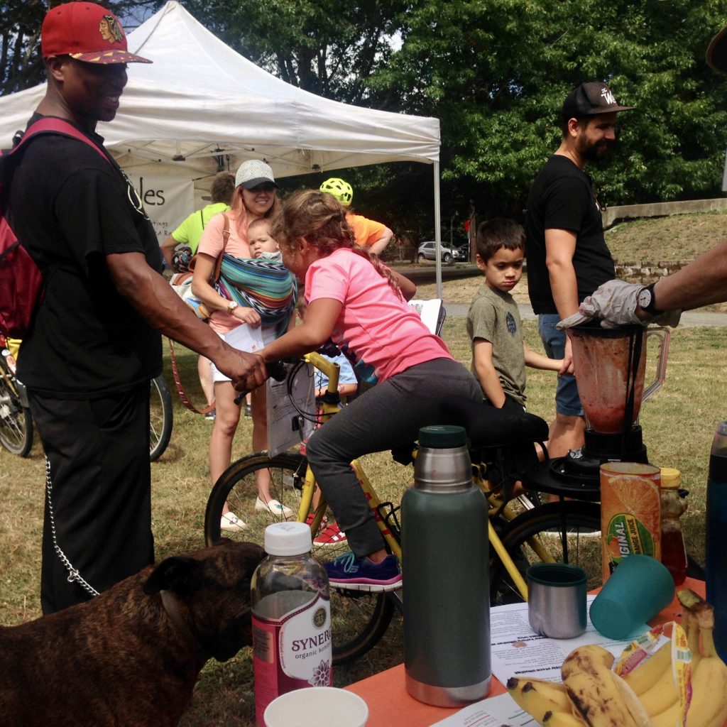 girl on bike with bike blender to make smoothies at Delridge Day