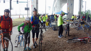 People with bikes, includng kids, gathered at our Bike Everywhere Day Celebration Station. West Seattle bridge in background.