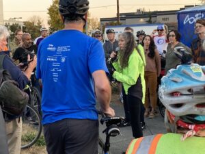 Claudia Mason speaking to bike riders gathered for memorial for Robb Mason at Spokane St Bridge. 